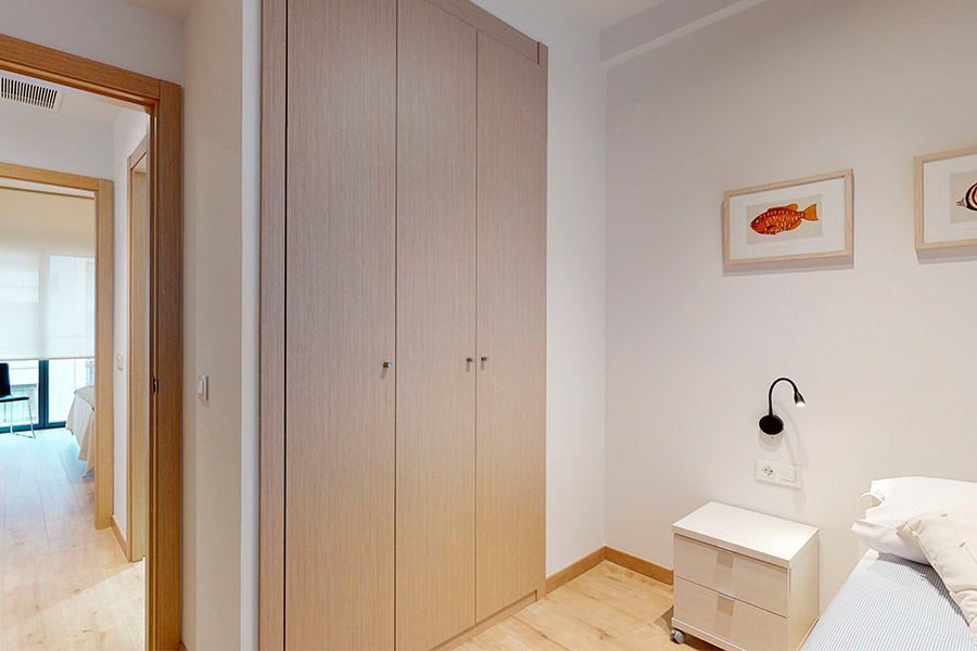 Detail of the built-in wardrobe in the room with trundle bed of the 2-bedroom flat A of the Proinca Moncloa Building