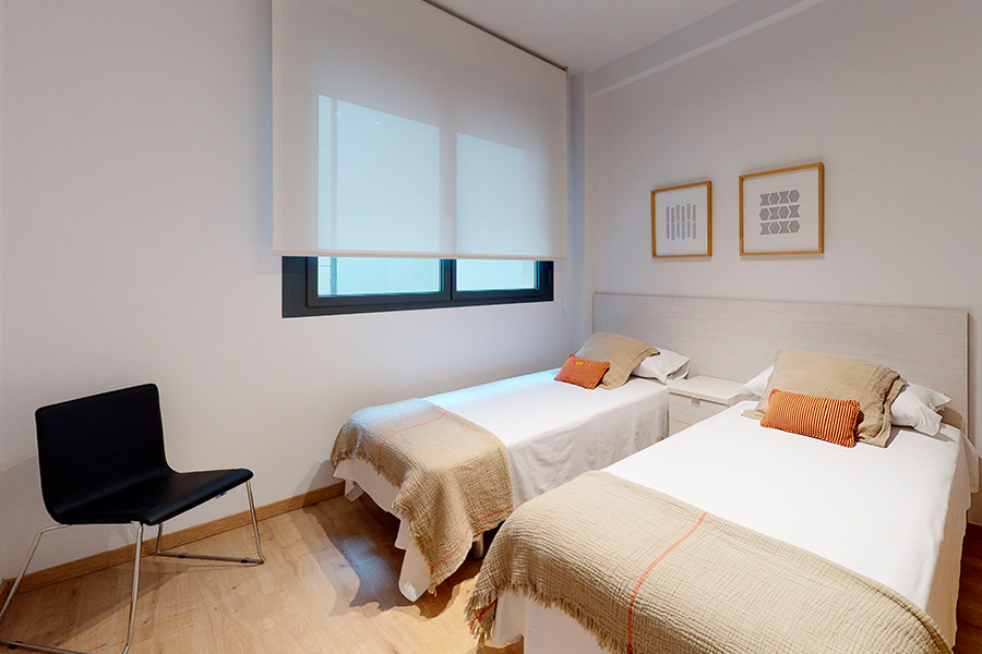 Close-up of the room with two beds in the 2-bedroom flat C of the Proinca Moncloa Building